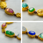 Collage of a gold necklace with colorful gemstones on a light background